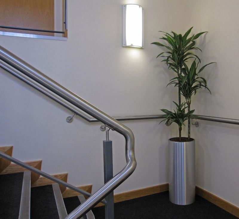 This tall circular plant display makes the main stairs to the first floor offices more welcoming