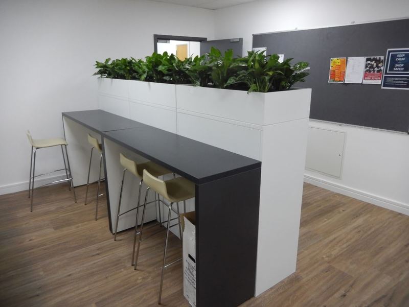 Cabinet top plant displays give privacy to this office breakout area