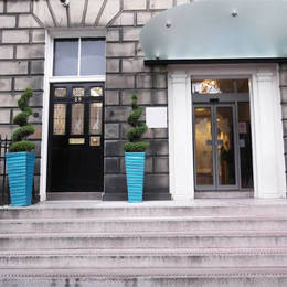 Contemporary Blue Stack planters create a striking exterior feature